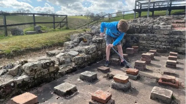 One of Sonya's children digs at the Roman fort