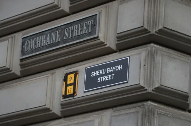 A sign alternatively naming Cochrane Street "Sheku Bayoh Street" in Glasgow.