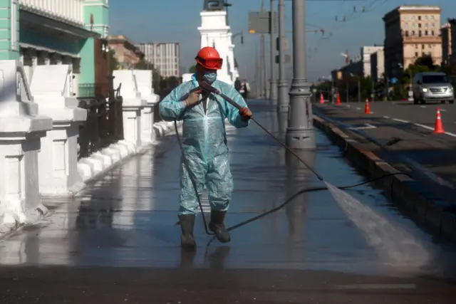 A person sprays the streets of Moscow with disinfectant