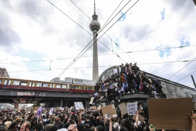 People demonstrate during a Black Lives Matter vigil at Alexanderplatz Square in Berlin, Germany 6 June 2020