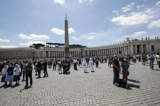 People gather on St Peter's Square, Vatican City, during the Angelus prayer of Pope Francis