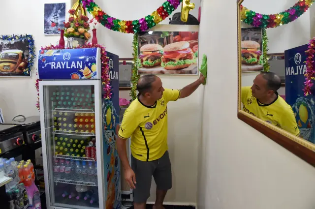 A man cleans his restaurant in Algeria