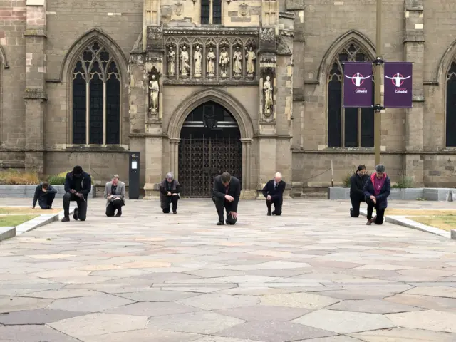 Bishop outside cathedral