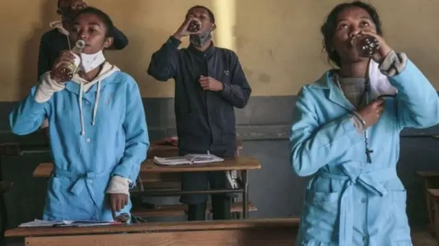 Students at a Madagascar school down Covid-Organics before classes begin