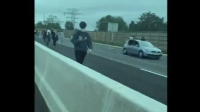 Protesters walking along the M6