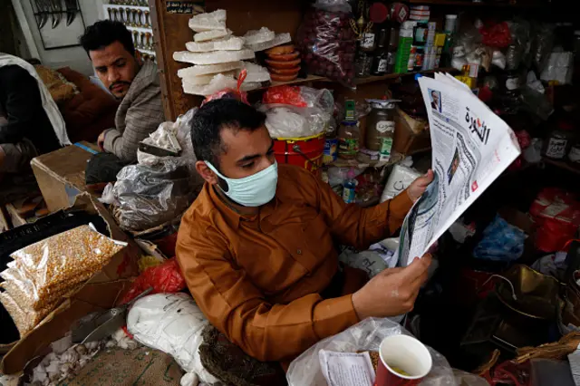 A Yemeni shopper wears a protective face mask