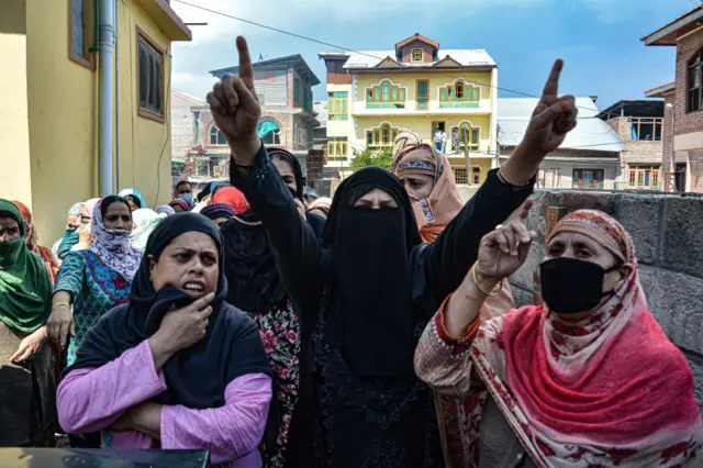 Women protest over nearly 15 residential houses being damaged during a gunfight between militants and security forces in Srinagar in Kashmir.