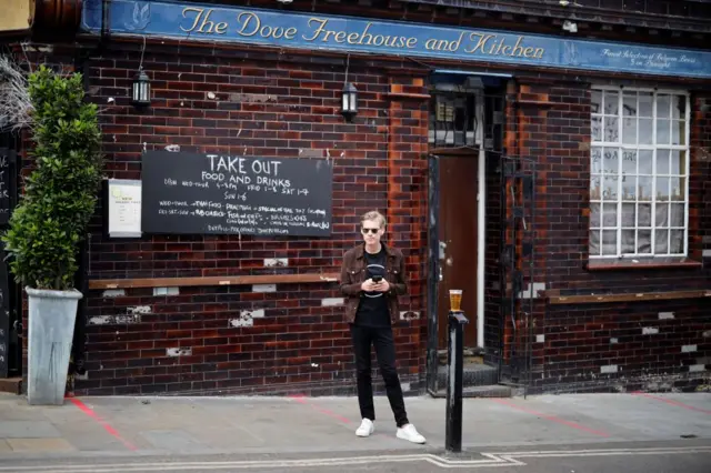 Man stands outside a London pub