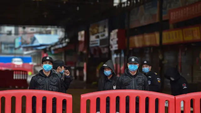 Police officers outside Huanan Seafood Market