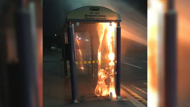 A bus stop on fire