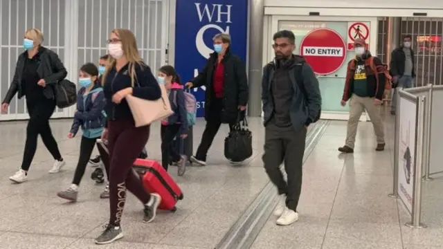 Passengers arrive at London Stansted Airport