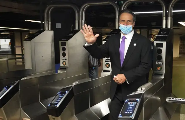 New York Governor Andrew Cuomo waves after riding the New York City subway 7 train into the city on June 8, 2020 in New York