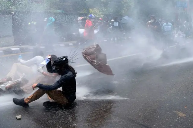 Police use water cannon to disperse demonstrators protesting against the governments policy on the fight against the COVID-19 coronavirus situation, in Kathmandu on June 9, 2020.