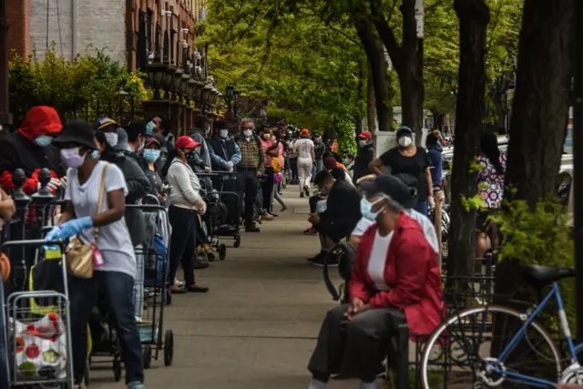 People wait on a long line to receive a food bank donation at the Barclays Center on May 15, 2020 in the Brooklyn boroughin New York City