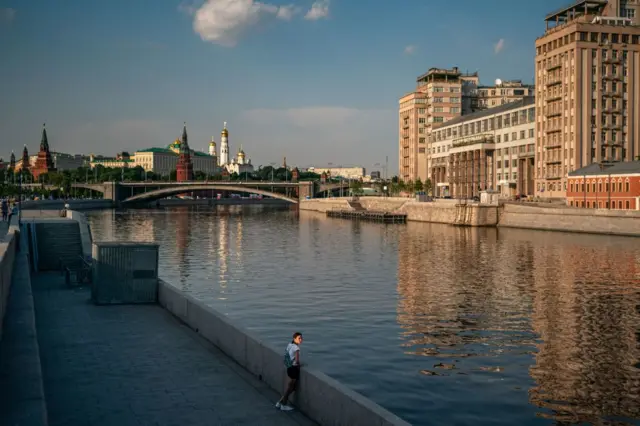 A woman stands on the embankment of the Moskva River in Moscow on June 8, 2020.