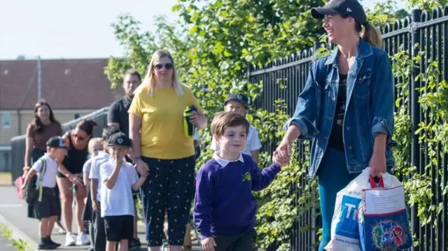 Parents and children outside a school