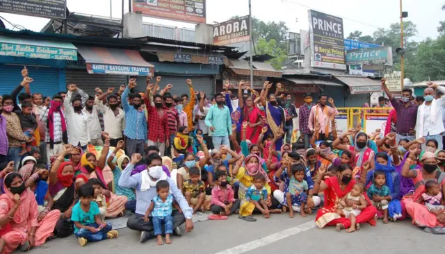 Migrant families from Chhattisgarh sitting on a protest outside the Amritsar railway station seeking arrangements to go home