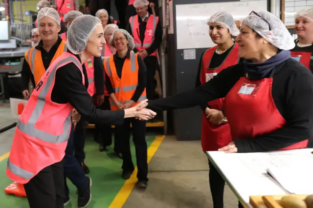 Prime Minister Jacinda Ardern meeting a worker