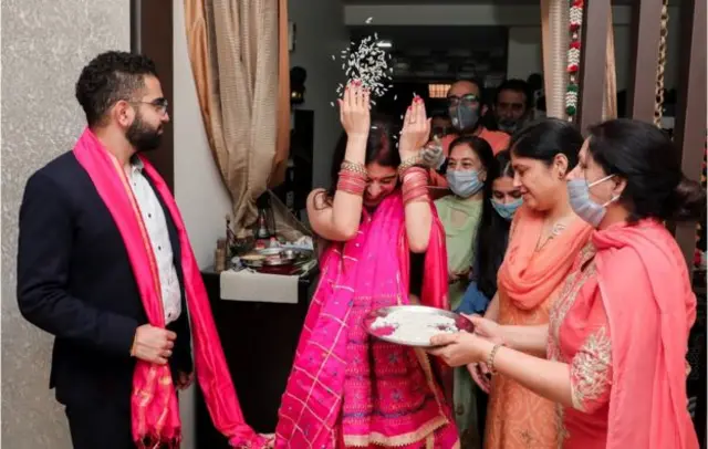 A bride and groom celebrate their wedding in India