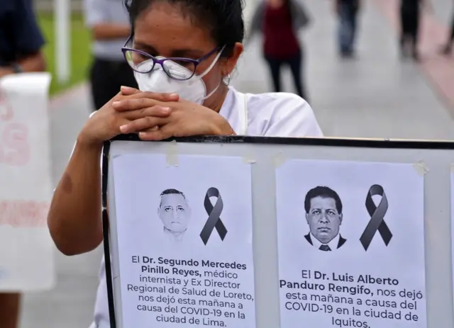 Portraits of medical staff who died from coronavirus at a vigil outside the regional government building in the city of Iquitos, Peru, on June 5, 2020