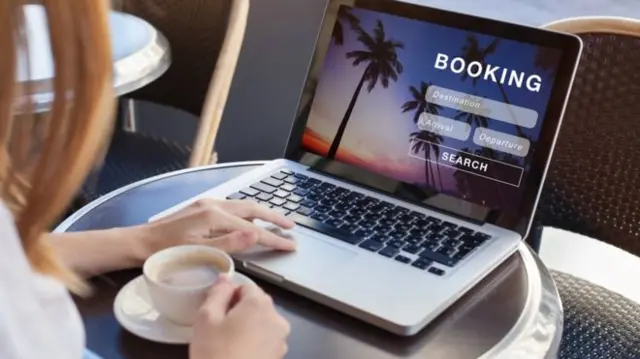 Laptop showing a screen for holiday bookings