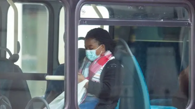 A bus passenger wearing a mask