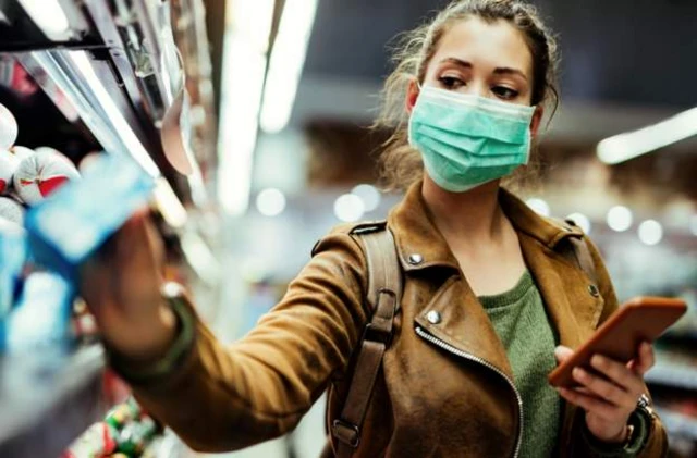 A woman wears a face covering in a shop