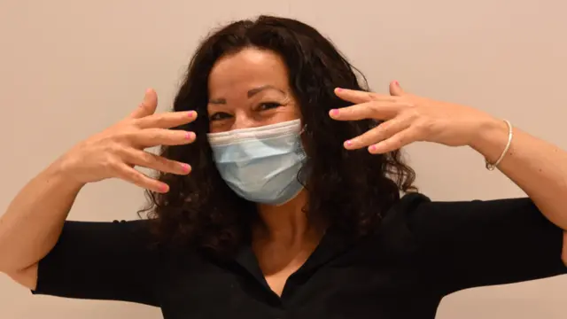 A woman shows her manicure