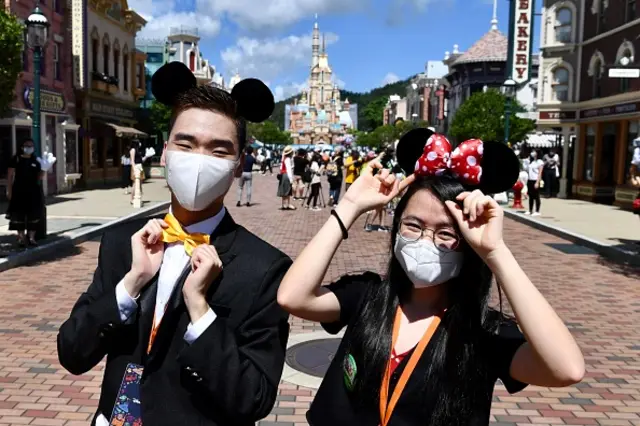 Visitors wear protective masks at Hong Kong Disneyland