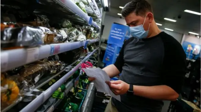 A man wearing a mask in a supermarket