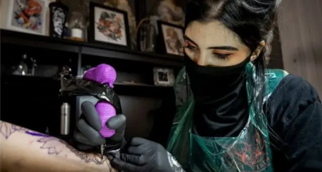 A tattoo artist at work