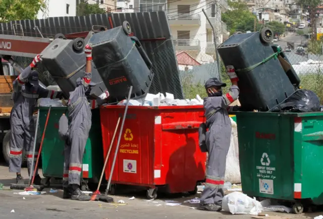 Bangladeshi employees of Ramco empty bins in Jdeideh, near Beirut