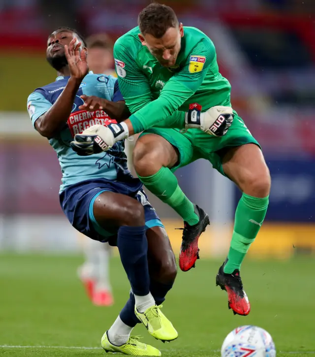 Simon Eastwood fouls Wycombe's Fred Onyadinma