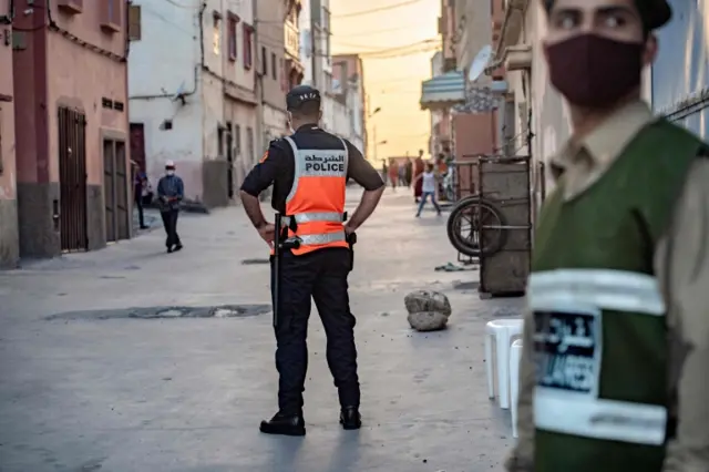 Moroccan policemen stand guard in a closed street in the city of Safi in June