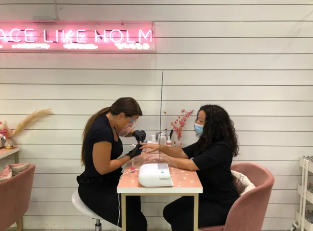 Nail technician Babs with customer Luce