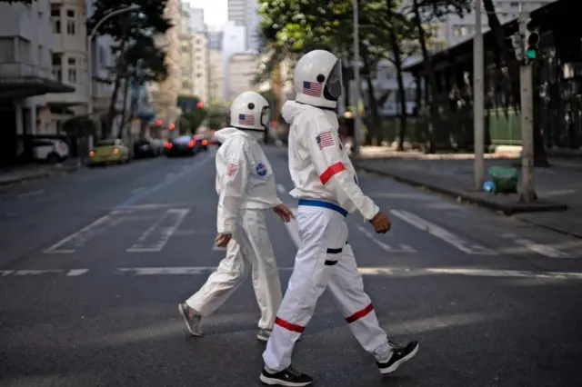 The couple crosses a street