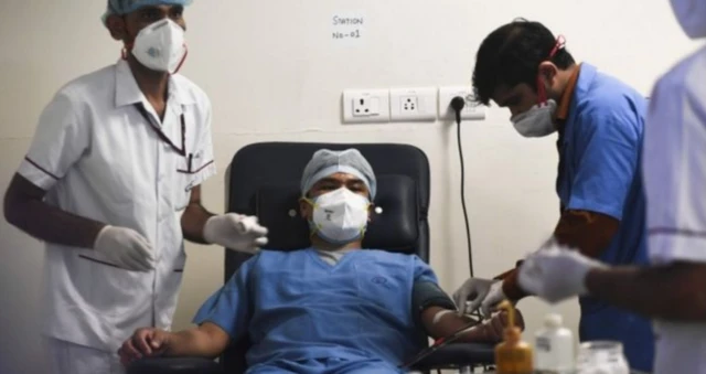 A man donating plasma in India