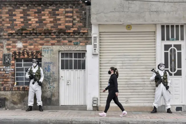 Soldiers in protective gears amid the COVID-19 pandemic stand guard in neighbourhood of Ciudad Bolivar in Bogota