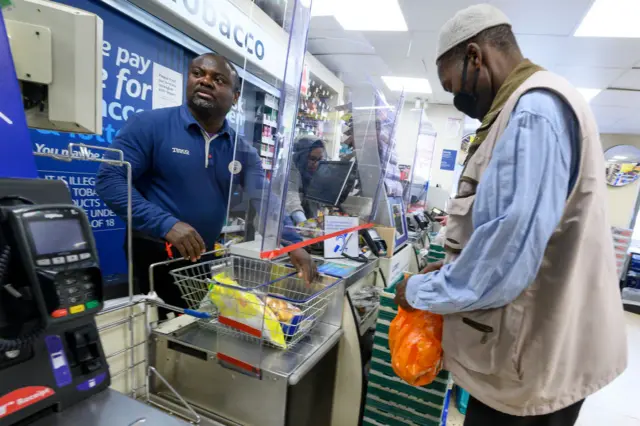 Cashier in London not wearing a face covering