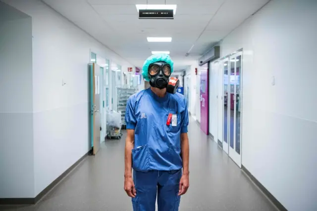 Karin Hildebrand, a doctor in an intensive care unit (ICU) in Stockholm's Sodersjukhuset hospital, is pictured with a protective face mask