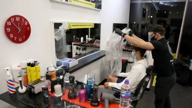 Tony Mann opened his barber shop in Giffnock just after midnight, and plans to cut hair for the entire day.