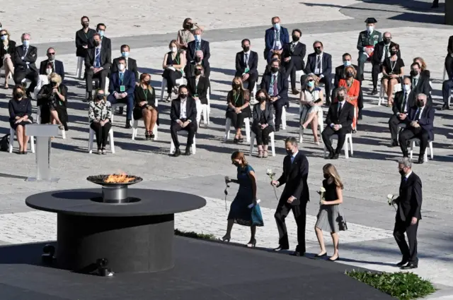 King Felipe, Crown Princess Leonor, and nurse Aurora Lopez (far left) laid flowers