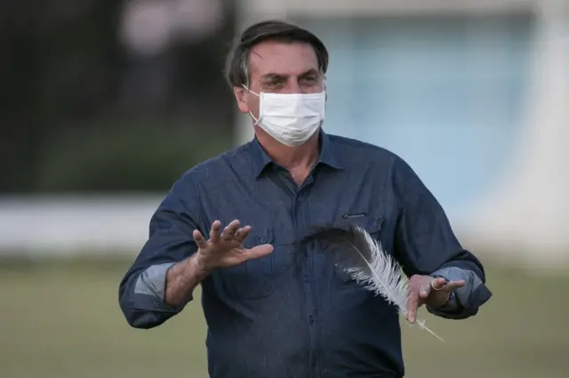 Brazilian President Jair Bolsonaro gestures in front of the official residence after testing positive for coronavirus (COVID-19) in Alvorada Palace on July 15, 2020 in Brasilia, Brazil.