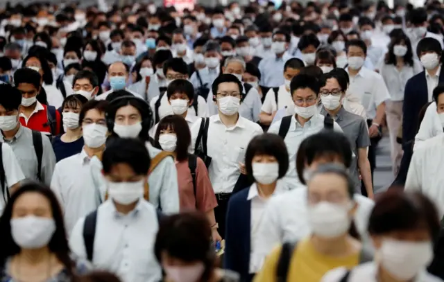 People wear their masks in Tokyo during rush hour