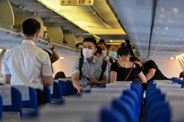 Passengers board a flight in China