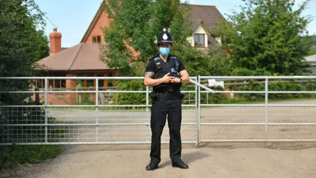 A police officer wearing a face mask at Rook Row Farm