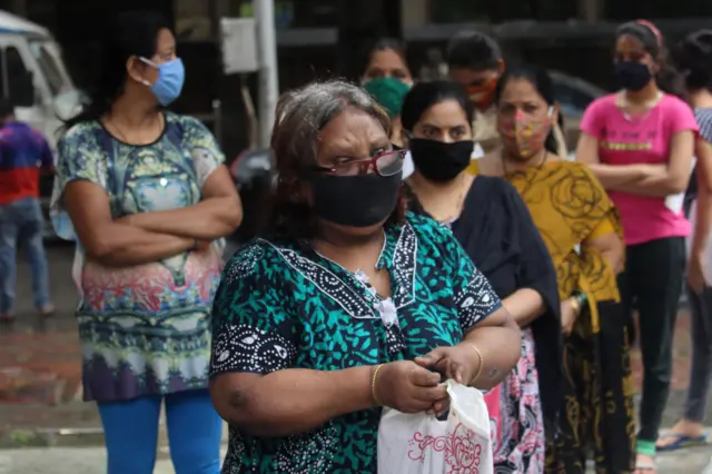 Women queue for a health check-up in India's worst-hit state, Maharashtra