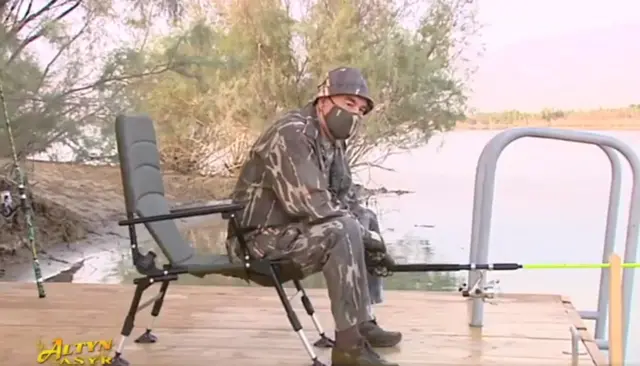 Gurbanguly Berdymukhamedov pictured wearing a mask while fishing