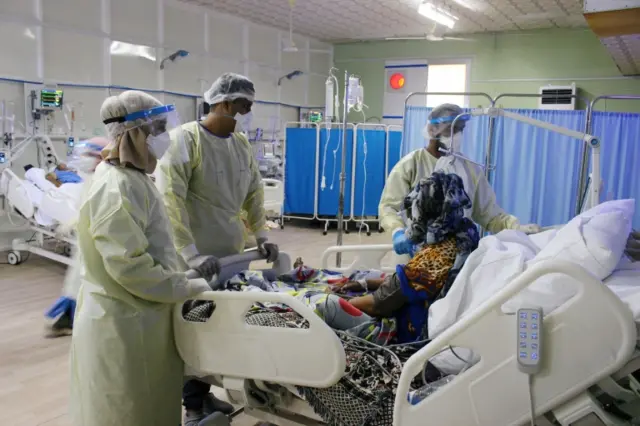 Doctors tend to a coronavirus patient in Yemen