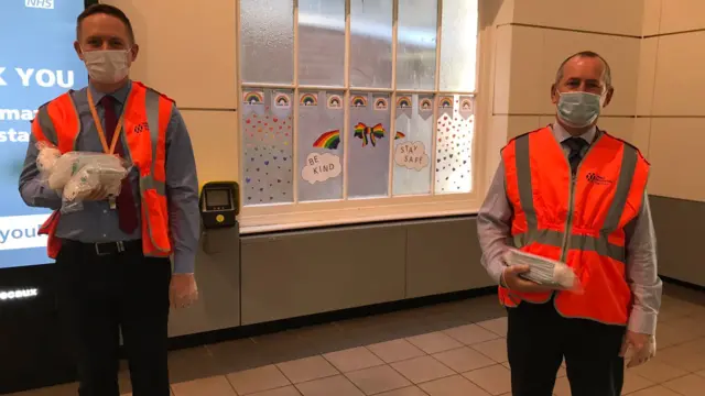 Face masks being handed out by West Midlands Trains staff